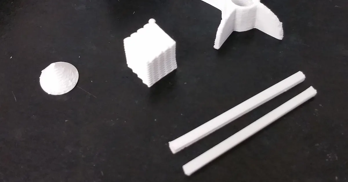 White alumina ceramic parts of several shapes on a black surface, ceramics similar to aluminum nitride parts