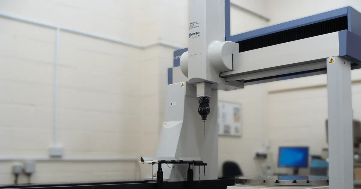 Bridge type coordinate measuring machine in an inspection room, used for CMM inspection of machined parts